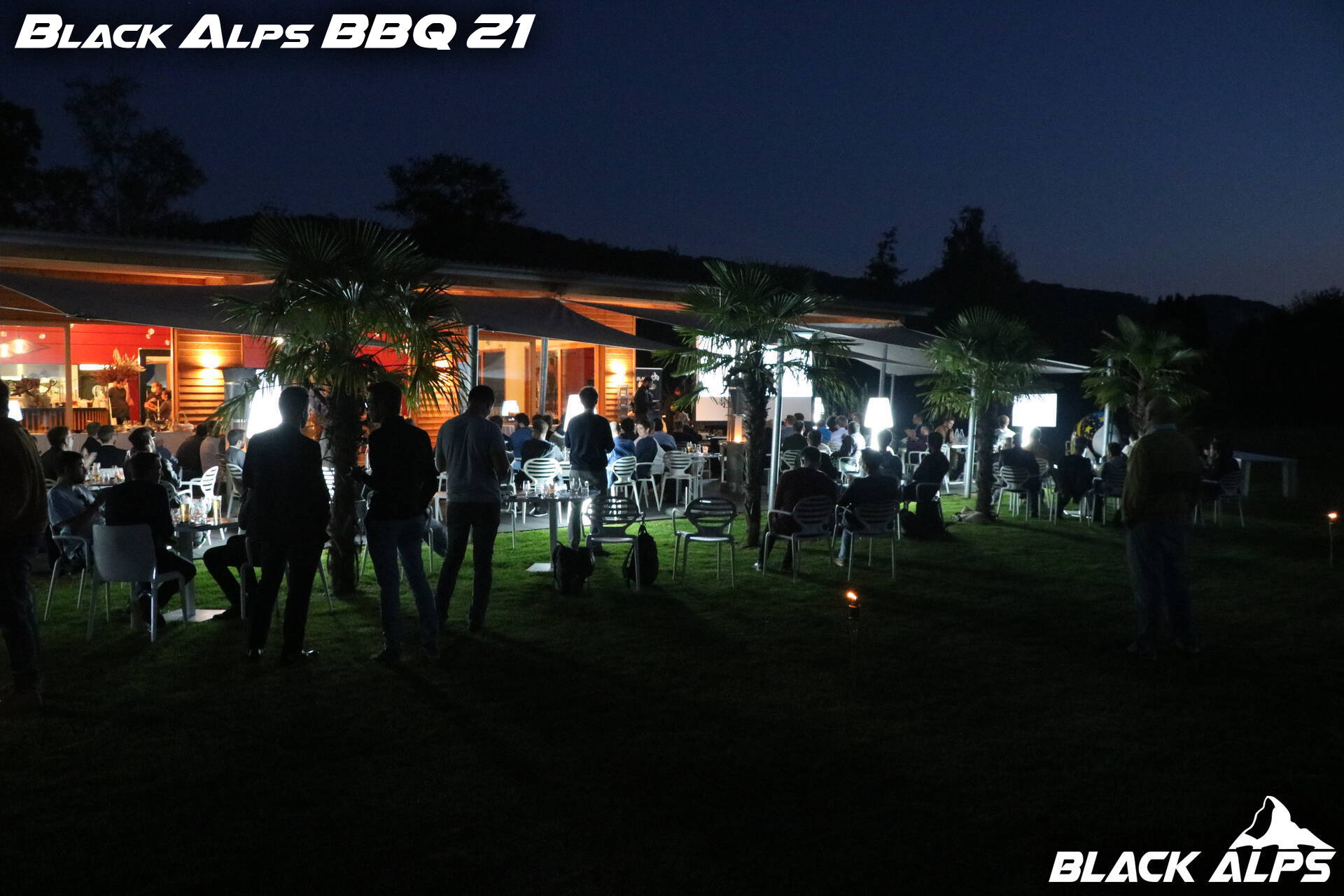 Guests socializing at the Black Alps BBQ event